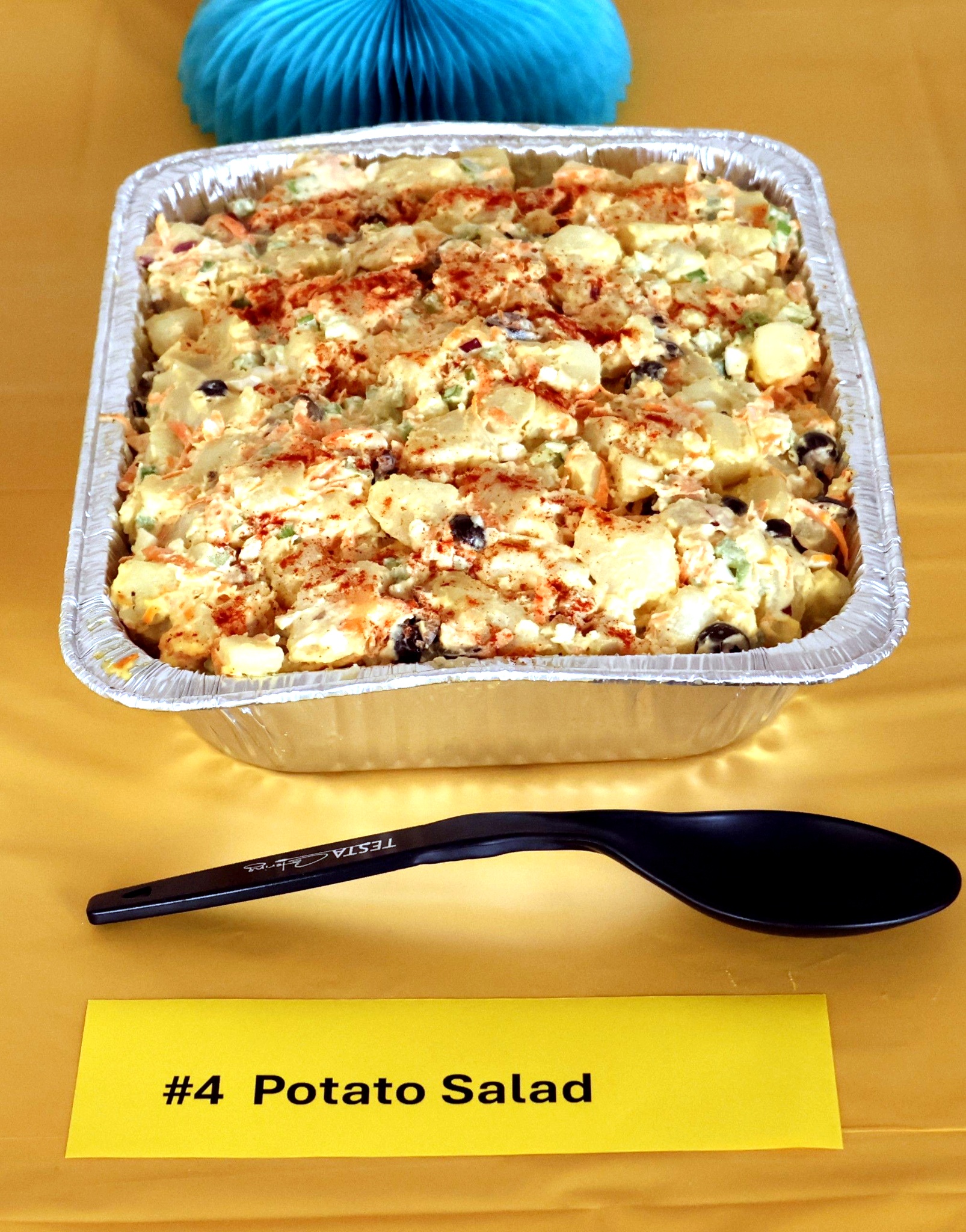 Image of potato salad on a yellow tablecloth